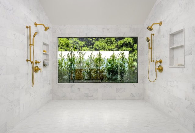 bathroom with a healthy amount of sunlight and a tile shower