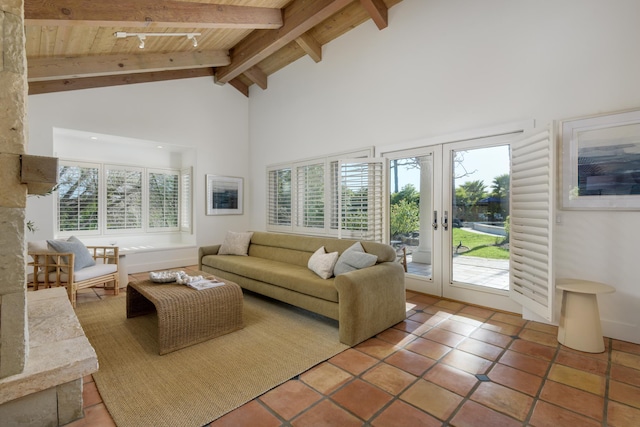 living area featuring wood ceiling, a healthy amount of sunlight, high vaulted ceiling, and beamed ceiling