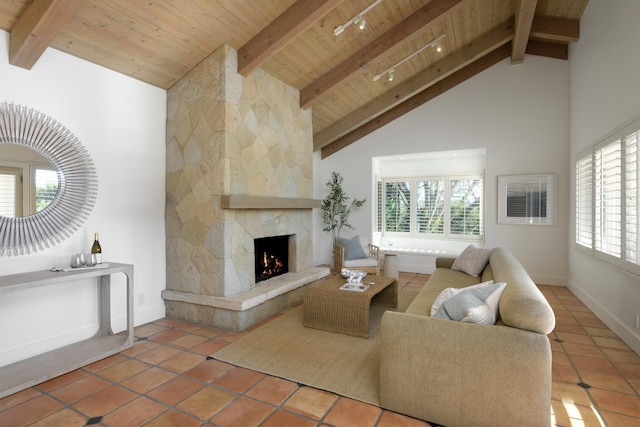living area featuring wood ceiling, beam ceiling, plenty of natural light, and tile patterned flooring