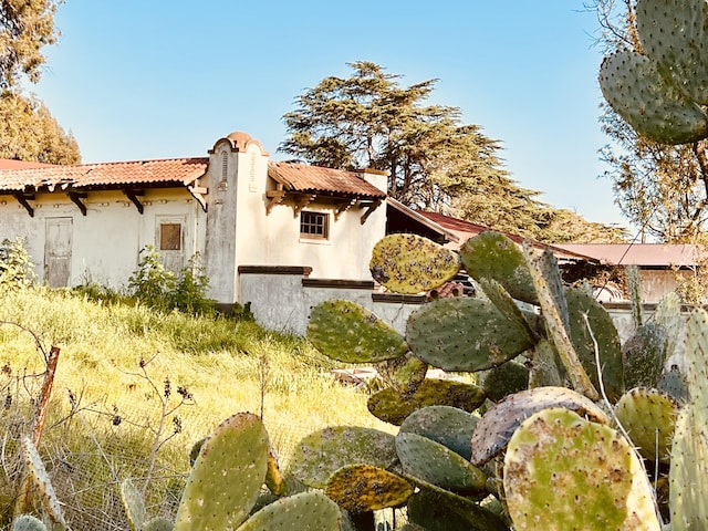 view of home's exterior featuring a tiled roof and stucco siding