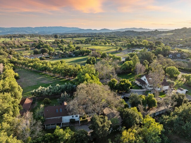 aerial view at dusk featuring a mountain view