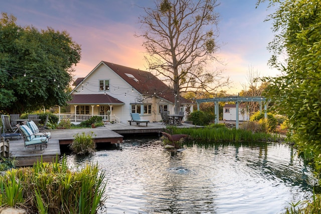 back of property with a deck with water view