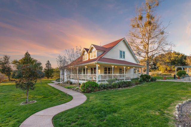 view of front of house with a porch and a front lawn