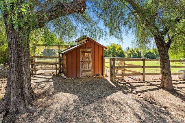 view of outbuilding with an outdoor structure and fence