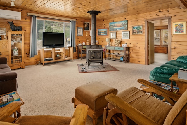 living area with wooden walls, a wall unit AC, wood ceiling, a wood stove, and carpet