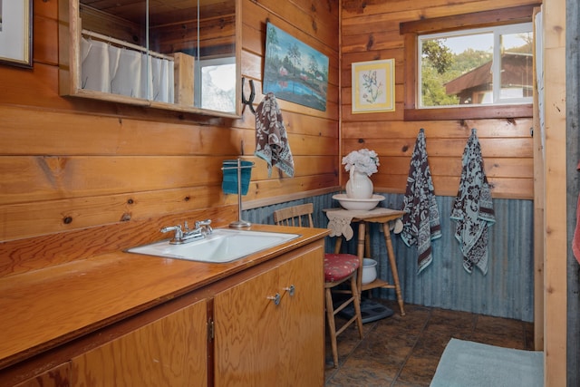 full bath with a shower with curtain, wooden walls, and vanity