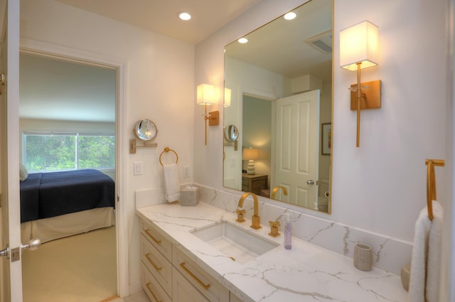 ensuite bathroom with recessed lighting, visible vents, connected bathroom, and vanity