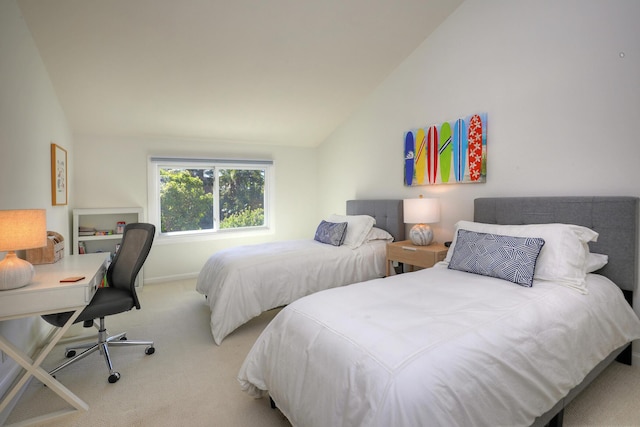 carpeted bedroom with lofted ceiling and baseboards