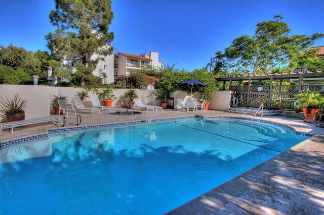 view of pool with a patio area, a fenced in pool, and fence