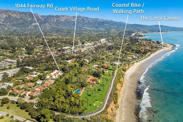 aerial view with a water and mountain view and a beach view