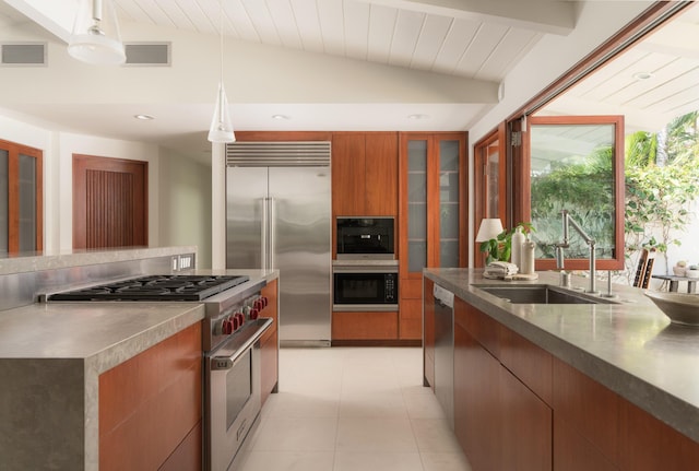 kitchen featuring visible vents, vaulted ceiling with beams, high quality appliances, modern cabinets, and a sink