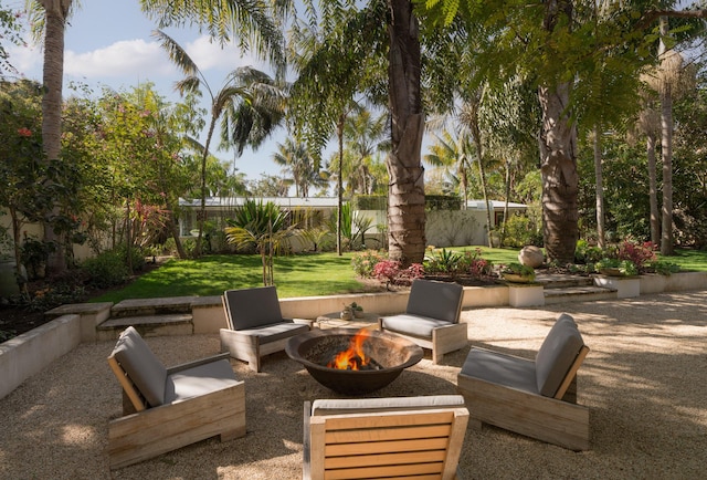 view of patio featuring fence and an outdoor fire pit