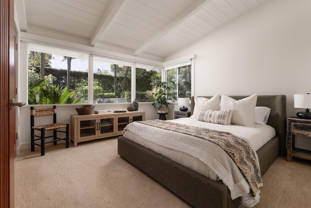 bedroom with lofted ceiling with beams, multiple windows, and carpet