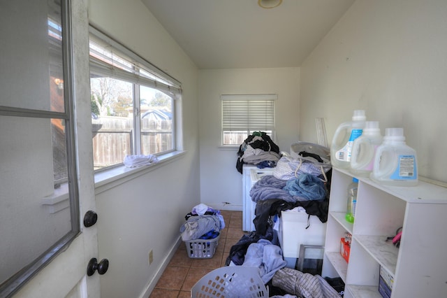 laundry area with baseboards and tile patterned floors