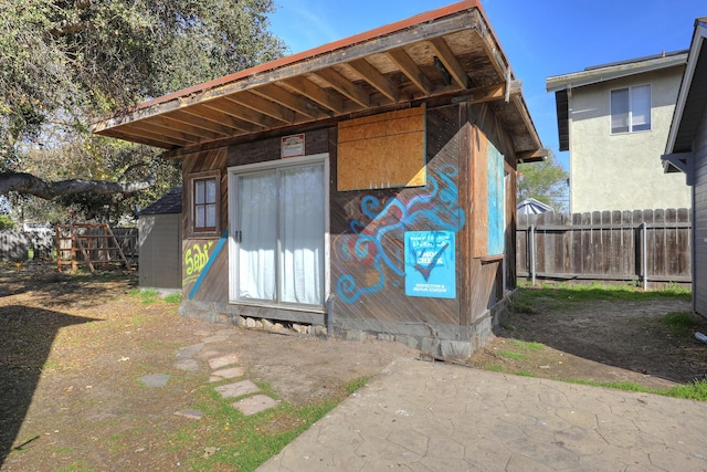 view of outbuilding featuring an outbuilding and fence