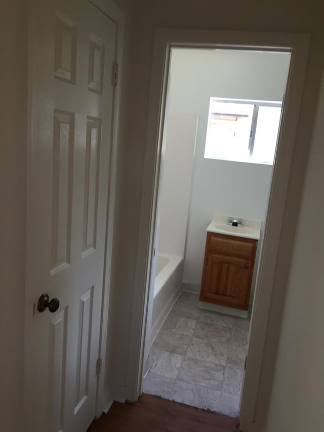 bathroom with a shower, vanity, and a bathtub