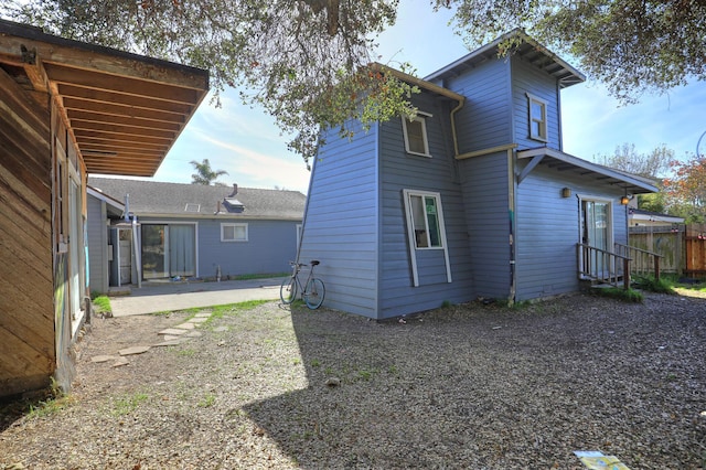 rear view of property with a patio and fence