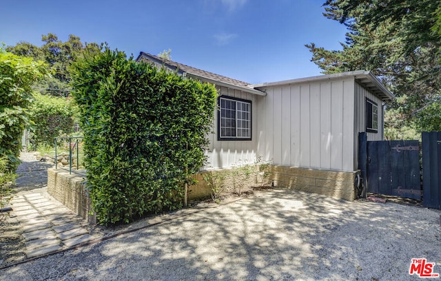 view of home's exterior featuring fence and board and batten siding