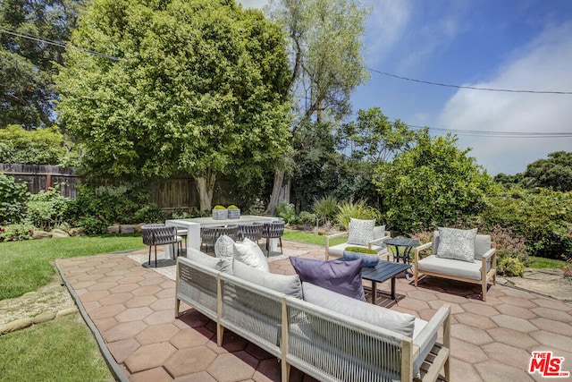 view of patio featuring an outdoor hangout area, outdoor dining area, and fence