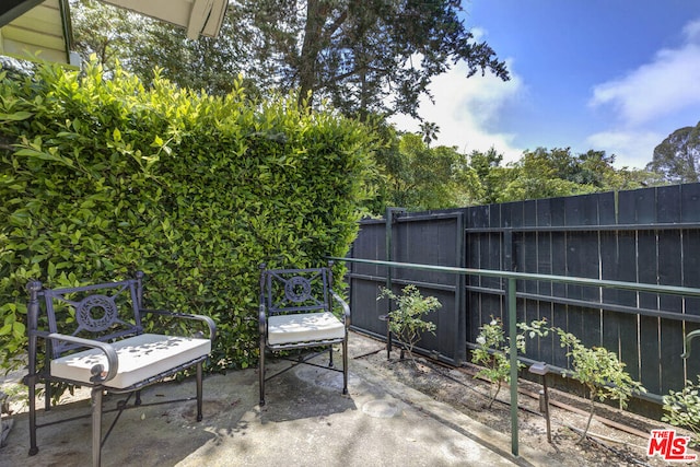 view of patio featuring fence