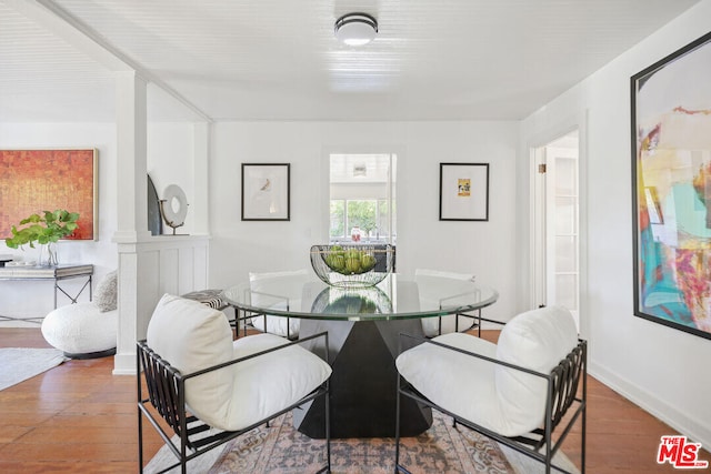 dining area featuring baseboards and wood finished floors