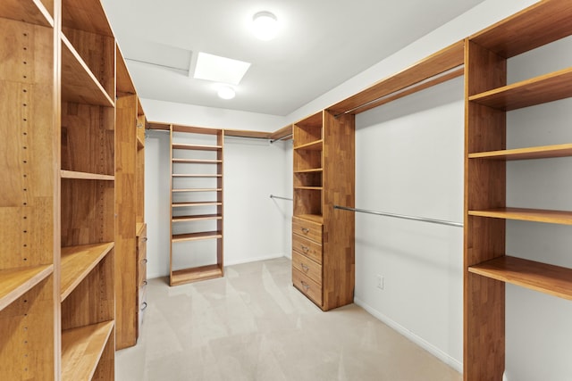 walk in closet featuring light colored carpet