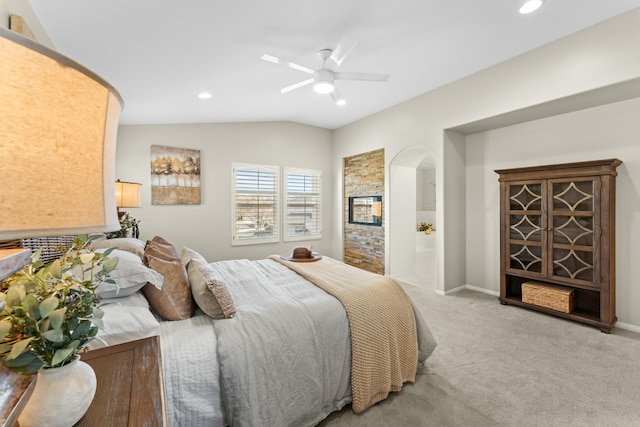 bedroom featuring baseboards, vaulted ceiling, light carpet, recessed lighting, and arched walkways