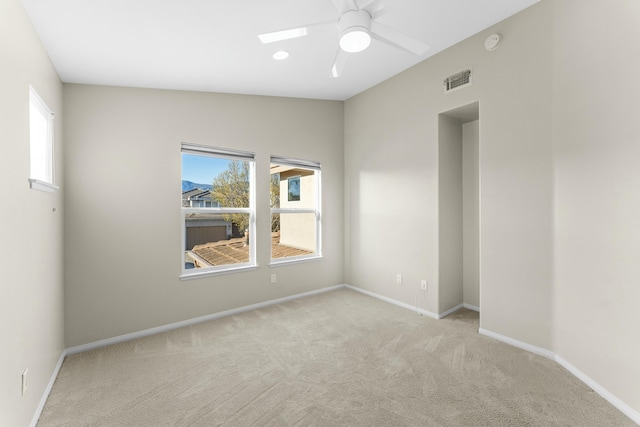 unfurnished room with visible vents, baseboards, carpet, and a healthy amount of sunlight