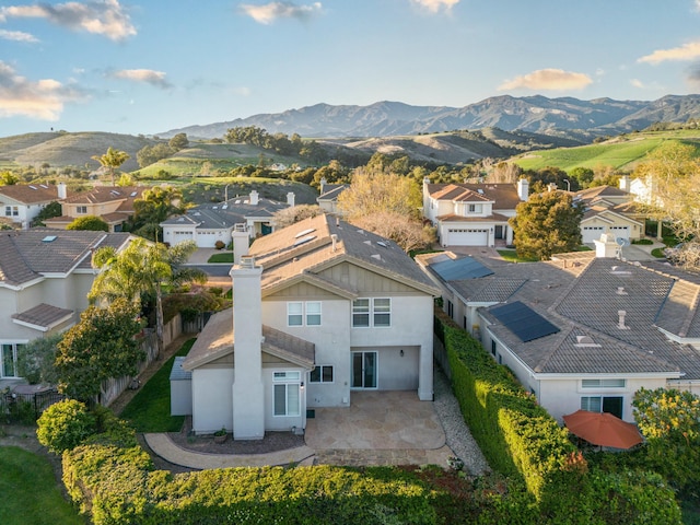 birds eye view of property with a mountain view and a residential view