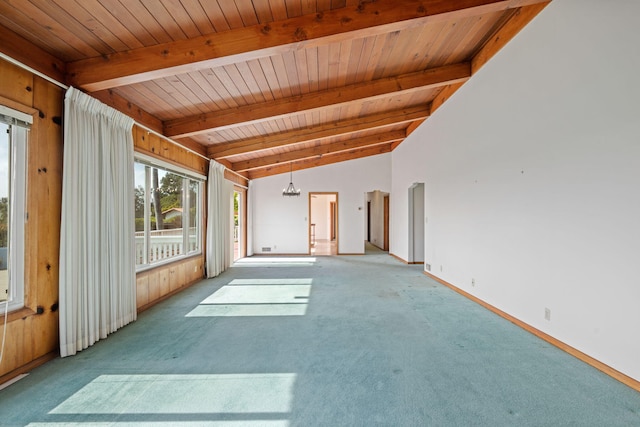 interior space with lofted ceiling with beams, baseboards, light colored carpet, and an inviting chandelier