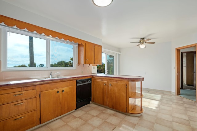 kitchen with tasteful backsplash, tile countertops, dishwasher, a peninsula, and brown cabinetry