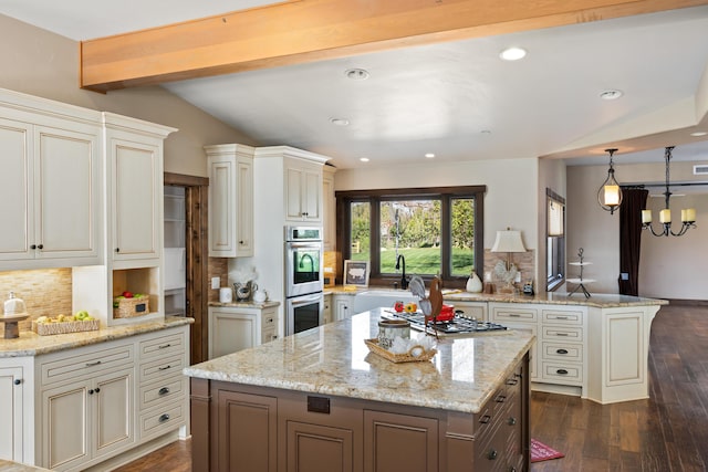 kitchen featuring a center island, dark wood-style flooring, stainless steel appliances, tasteful backsplash, and a sink