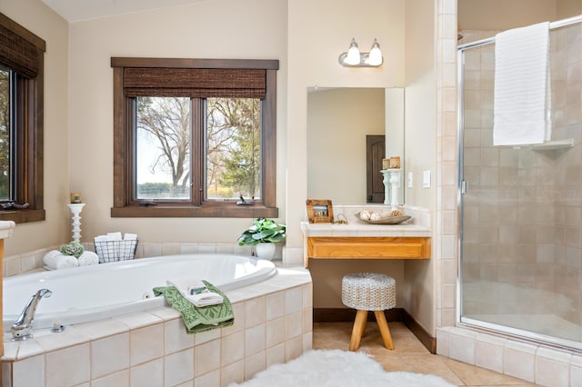 bathroom featuring lofted ceiling, tile patterned flooring, a garden tub, vanity, and a stall shower