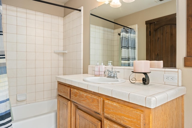 bathroom featuring shower / tub combo and vanity