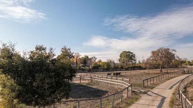 surrounding community with a rural view and fence