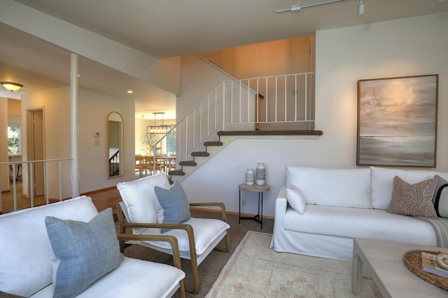 living room with stairway and baseboards