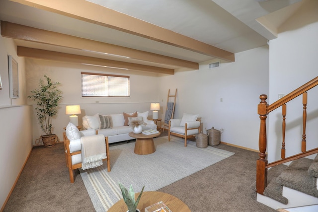 carpeted living room with beam ceiling, visible vents, stairway, and baseboards