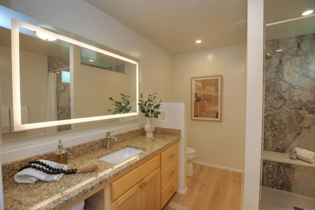 full bathroom featuring vanity, wood finished floors, baseboards, curtained shower, and toilet