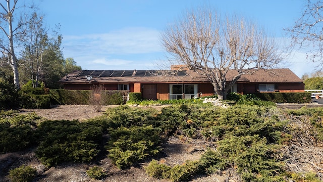 view of front of property with solar panels