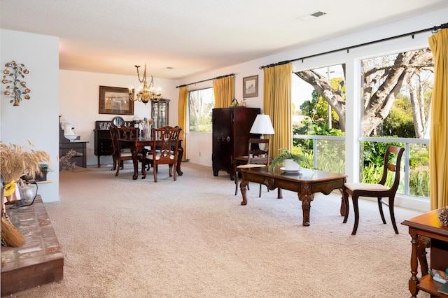 interior space with carpet, visible vents, and a chandelier