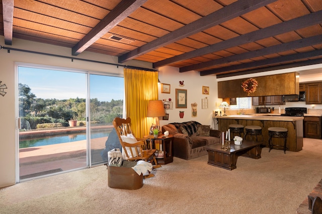 living area featuring carpet floors, beamed ceiling, wooden ceiling, and visible vents