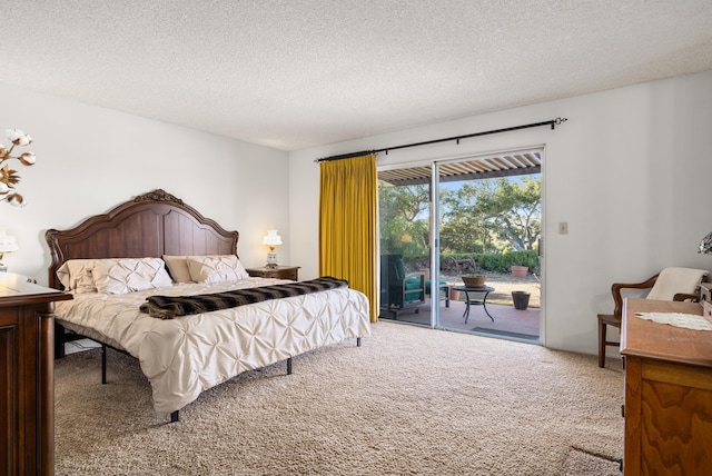 bedroom featuring a textured ceiling, access to outside, and carpet flooring