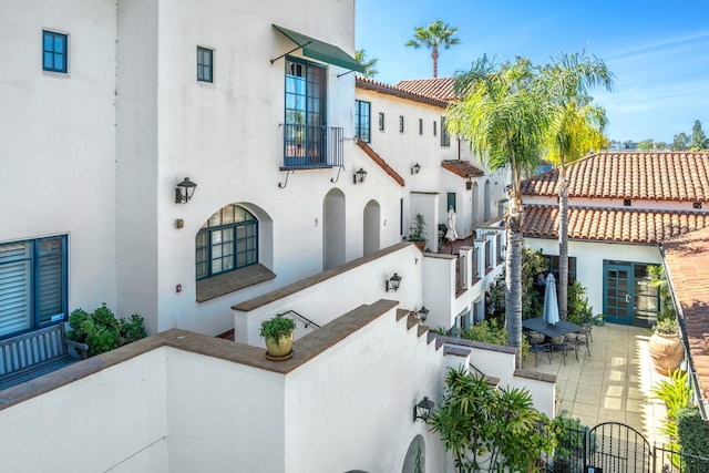 exterior space with a fenced front yard, a patio, and stucco siding