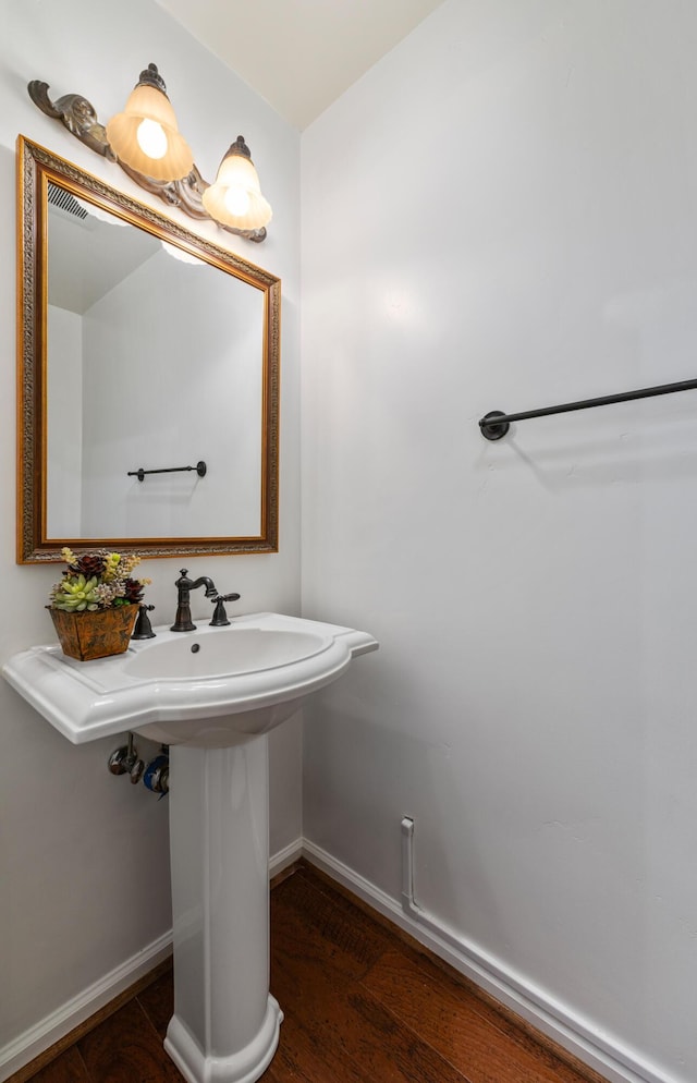 bathroom featuring wood finished floors, visible vents, and baseboards