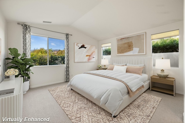 carpeted bedroom featuring lofted ceiling, baseboards, and visible vents