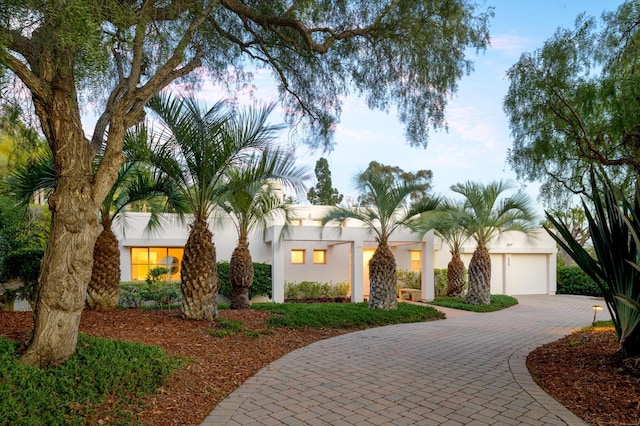 adobe home with driveway and stucco siding