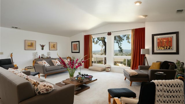 carpeted living area featuring vaulted ceiling and visible vents