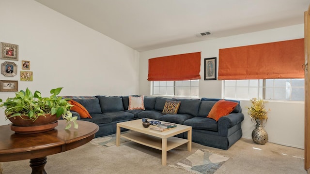 carpeted living room featuring visible vents and vaulted ceiling