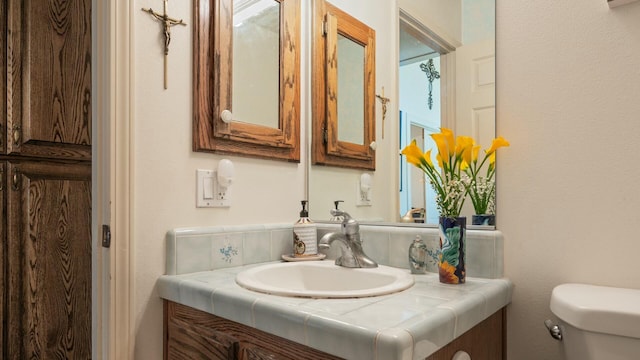 bathroom with toilet and vanity