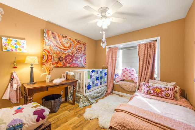 bedroom with wood finished floors and a ceiling fan